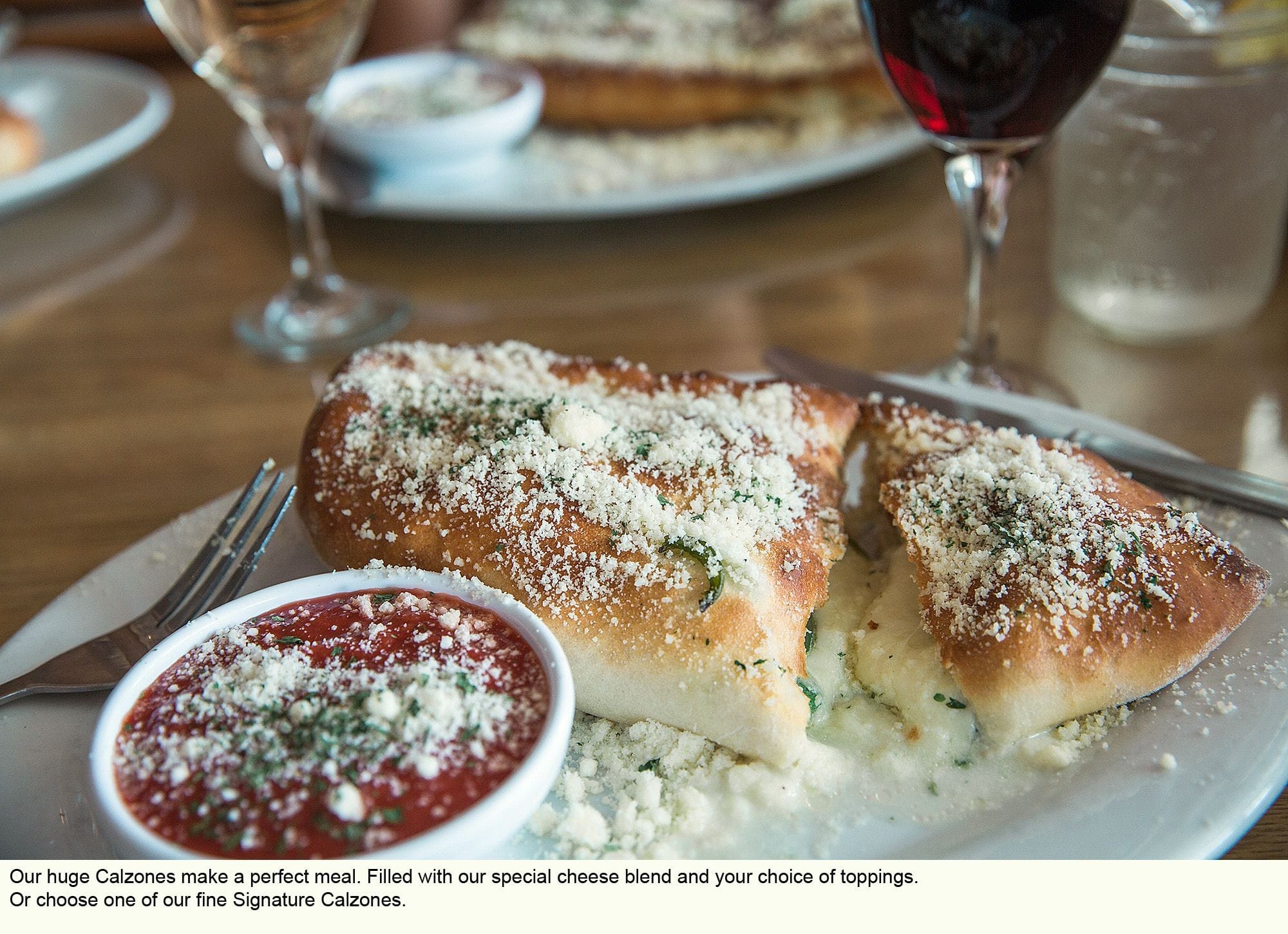 Photo of Calzone with side of dipping sauce.